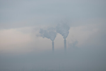 a factory in the distance. Smoking chimneys