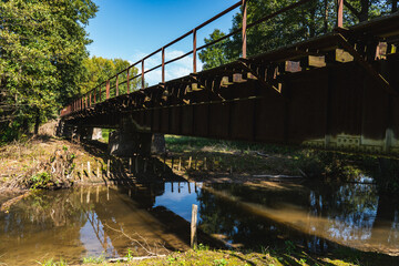landscape with an old steel railway bridge crossing the river