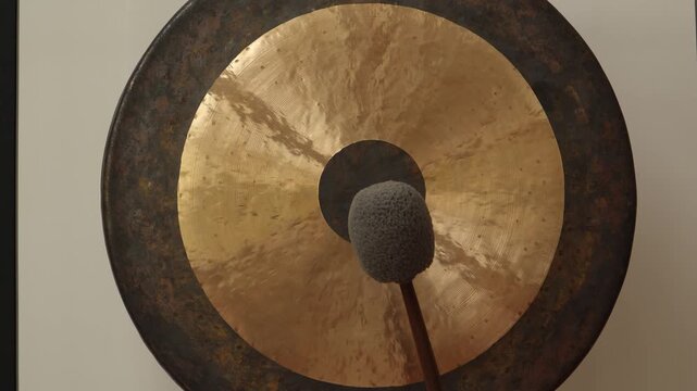 Close-up view of Tibetan gong being played