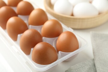 Raw chicken eggs on white table, closeup