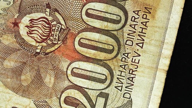 Yugoslavia twenty thousand dinar banknote obverse with large numeral rotating on black background