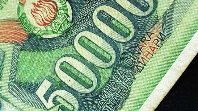 Yugoslavia fifty thousand dinar banknote obverse with large numeral detail rotating on black background
