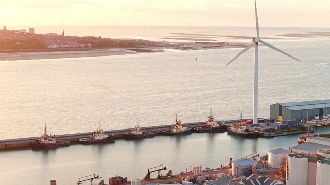 Cinematic aerial drone footage of the surrounding docks and wind turbine near Everton FC&rsquo;s new Bramley-Moore Dock stadium in Liverpool, England. Captured at sunset.