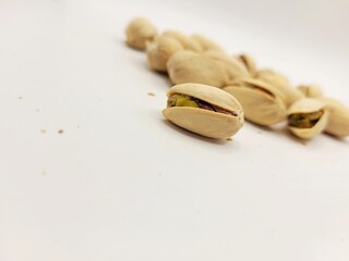 Pile of pistachios on bright background