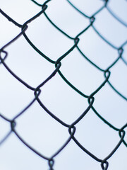 Fototapeta premium Abstract Chain Link Fence Pattern with Selective Focus - Minimalist Wire Mesh Texture with Soft Bokeh Background