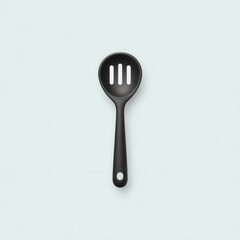 Simple black slotted spoon placed on a light blue background in a modern kitchen setting