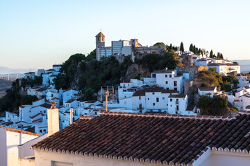 Casares, Andalusia, Spain. 5 September 2025. Rooftops with mountain landscape at sunset.