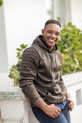 Fototapeta premium Handsome man in a hoodie enjoying autumn in sunny Miami