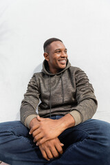 Fototapeta premium Handsome man in a hoodie enjoying autumn 