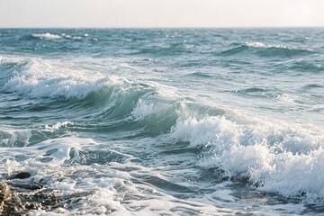 Ocean waves crashing on shore with white foam and clear water