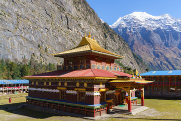 Golden temple nestled beneath majestic snowy mountains © Jeroen Kleiberg