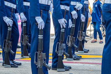 Soldiers parade with their service rifles.