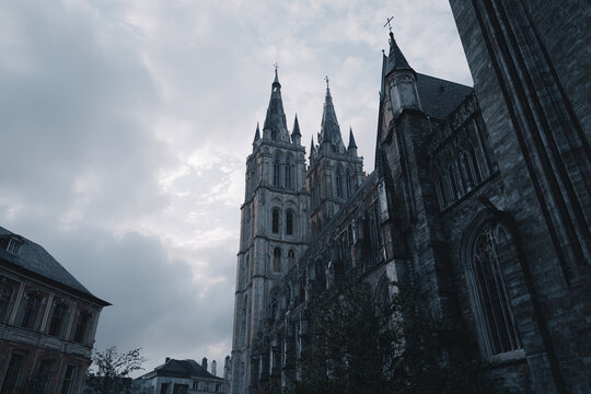 Classic European cathedral with detailed gothic spires, cloudy moody sky - Powered by Adobe