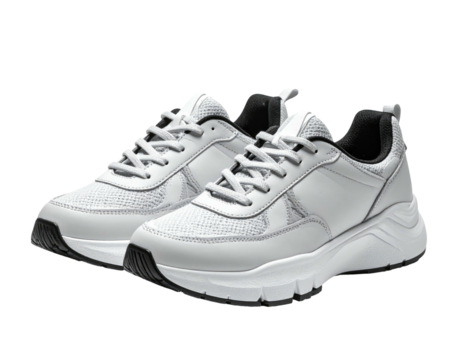 White and black sneakers with mesh and a chunky sole are displayed on black