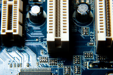 Close-up of an assembled electronic printed circuit board with slots and connectors