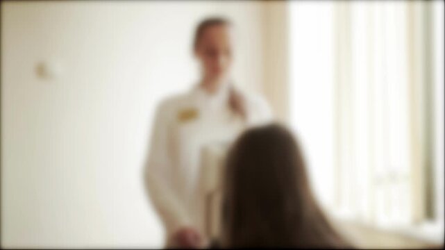 Girl patient at an appointment with an ophthalmologist looks into diagnostic equipment ophthalmological tomograph. Diagnostics of the structure and cornea of the eye, background, blurred. Copy space f