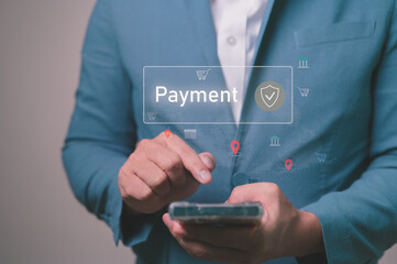 Online payment and mobile banking concept. A businessman uses a smartphone for secure digital transactions and e-commerce. Financial technology (Fintech) with a digital wallet for online shopping.