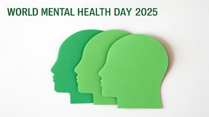 World Mental Health Day 2025 Three green paper head silhouettes represent World Mental Health Day 2025, emphasizing mental health awareness.