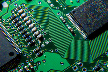A close-up of an electronic circuit board with a microcircuit and SMD components