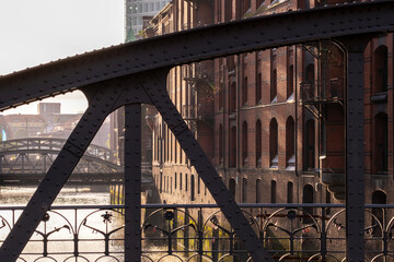 Closeup of Speicherstadt iron bridge and historic warehouses in Hamburg symbolizing industrial heritage and architectural rhythm