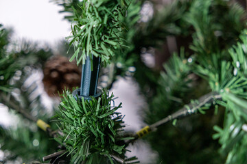 close-up of artificial christmas tree branch connection during assembly process