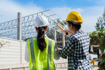 Engineers inspecting construction site discussing building project