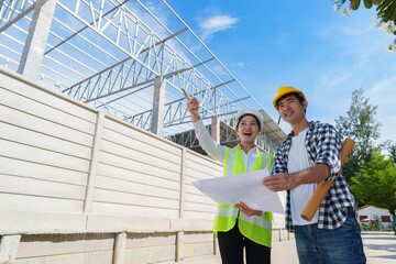 Engineers discussing construction project plans at building site