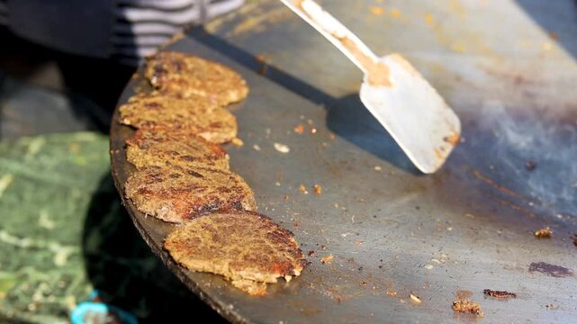 indian street food oily fried kebab roll preparation on pan