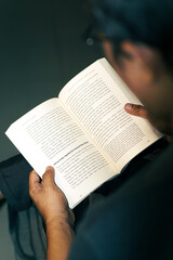 A quiet page can change your entire world - Man Reading a Book Indoors