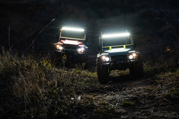 Radio-controlled cars driving off-road at night with led lights © Zoran Jesic