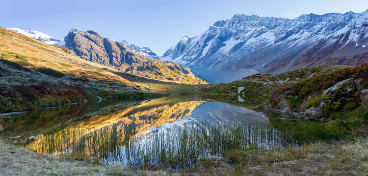 Mountain lake with reflection in swiss alps. Lake Guggisee perfectly reflects scenery in loetschental, valais switzerland
