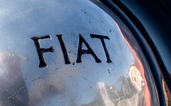 Close up of vintage Fiat brand logo on old car in exhibition during a vintage car rally in Varallo Sesia, Italy, September 29, 2025