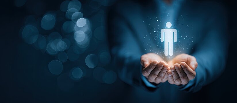 A person's hands cradle a glowing human silhouette icon, with a blurred blue bokeh background