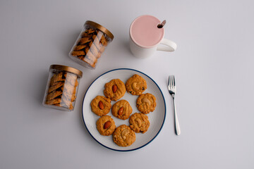 Almond cookies in a cookie box and placed on a plate on the table.