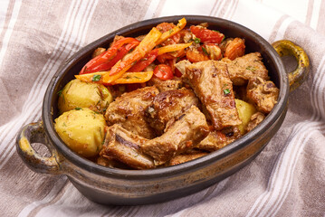 Roasted Pork Ribs with Potatoes, Carrots, Herbs. Fresh Food Dish.