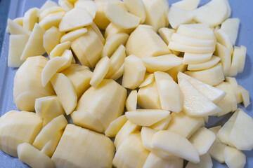 Slice potato on cutting board with knife. Cooking meal
