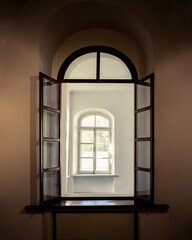Open arched window with view to another window