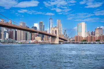 Majestic Brooklyn Bridge graces the NYC skyline. Soaring steel arches frame the cityscape, bathed in warm sunlight. Iconic landmark for travel and architecture projects. wallpaper, 4k
