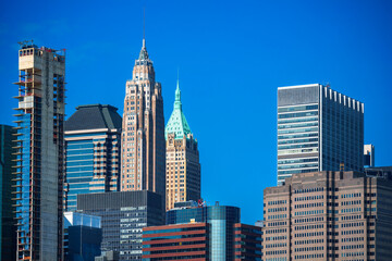 40 Wall Street (The Trump Building): This is the slender, historic skyscraper with the prominent green/gold pyramid-shaped roof and spire. Lower Manhattan skyline in New York City