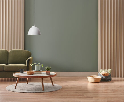Green living room wall background with grey decorative chair, lamp frame middle table and poster style.