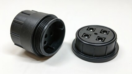Black plastic connector cap and housing with four contact pins for electrical applications