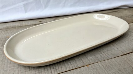 Elegant oval plate on wooden surface with soft lighting