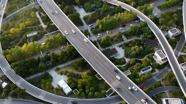 Aerial View of Busy Highway Overpass Traffic Intersection with Green Residential Neighborhood