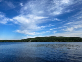 Scenic Summer Lake View with Forest Hills and Clouds in Vuokatti, Finland