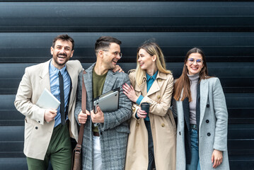 IT experts freelance workers innovative technology developers, working on a new project staff meeting with casual talk in formalwear outside office building before the work. Discussing business people