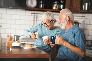 Senior couple during a healthy breakfast in their kitchen