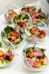 Party catering setup with sandwiches and canapés on buffet table
Buffet catering with assorted sandwiches on trays, party finger food and appetizers on a white table at corporate event
Catering buffet