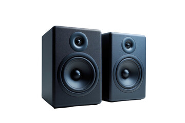 Two dark, box-shaped speakers with circular components against a stark black background
