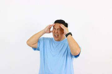 Young asian guy suffering from badheadache