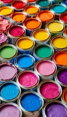 Fototapeta premium a vibrant and colorful overhead view of numerous small paint cans filled with various shades of paint.